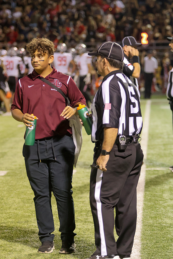 Junior Derrick Locket provides the referee the water.