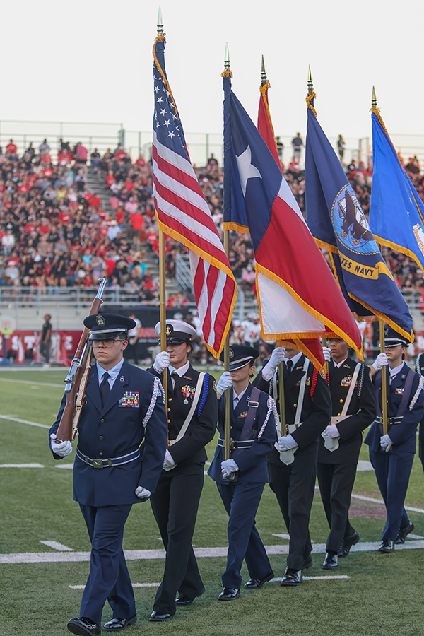 NJROTC cadets walk of the field following the national anthem.