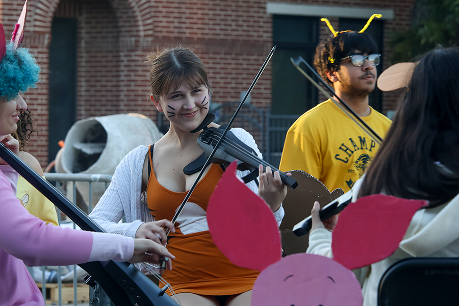 Senior Penelope Valtierra performs with orchestra during the homecoming  parade.