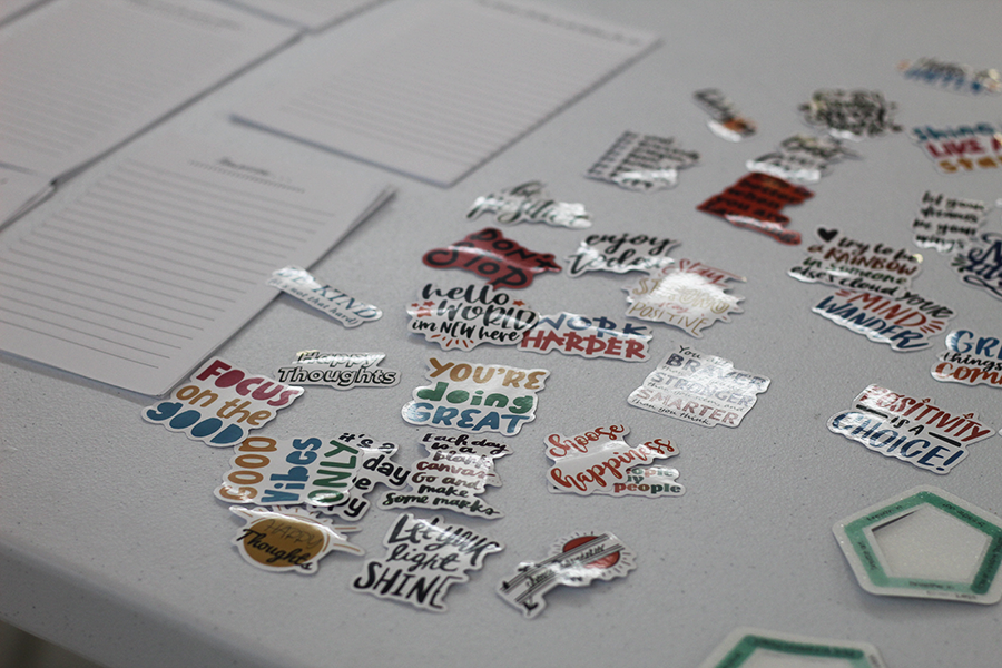 A closeup of motivational and positive stickers are placed around the table.